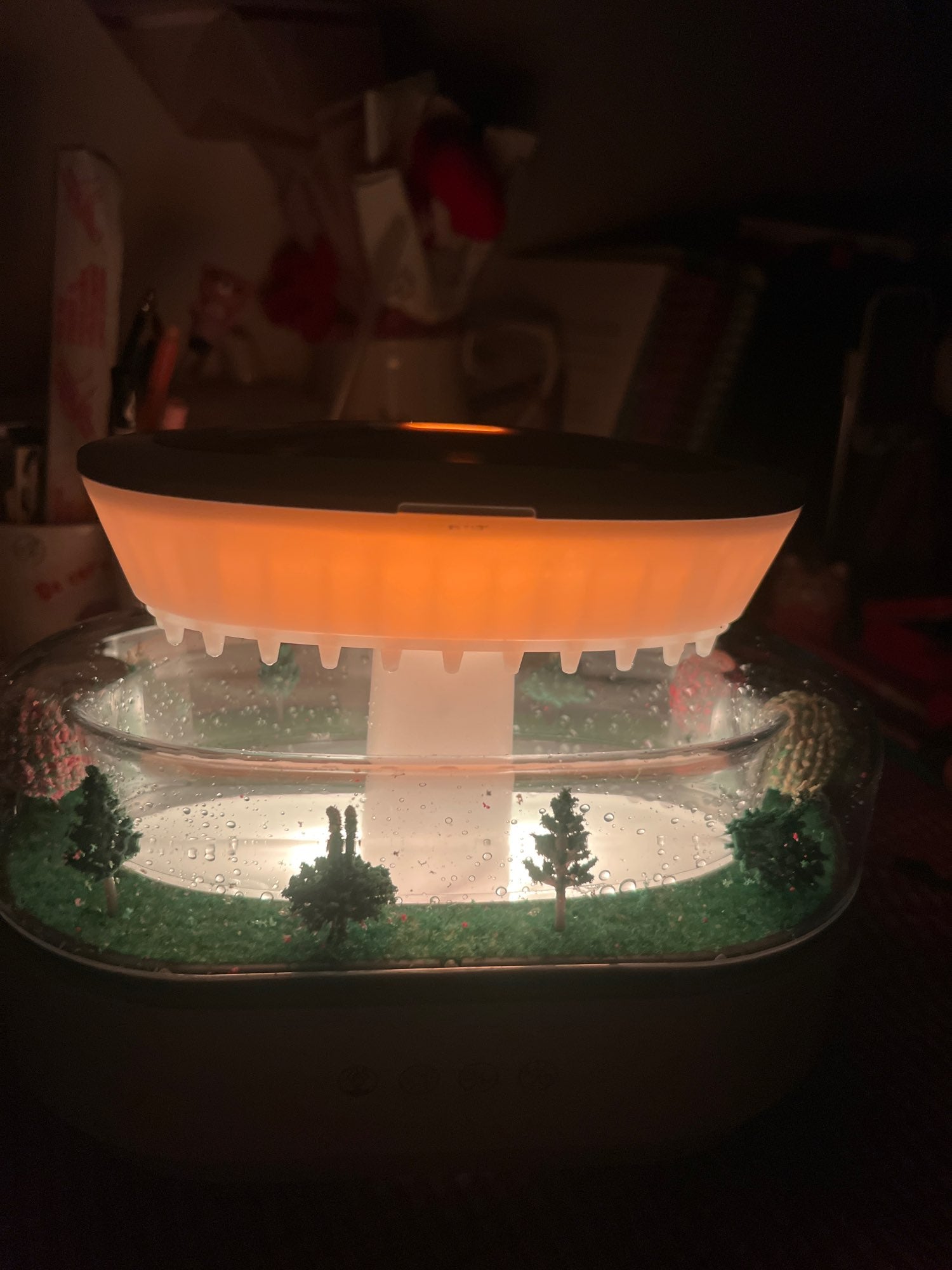 Misthaus on bedside table, warm orange glow